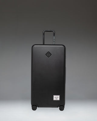 Front view of the Herschel Heritage Hardshell Large Luggage in black, showing its durable, textured exterior design.