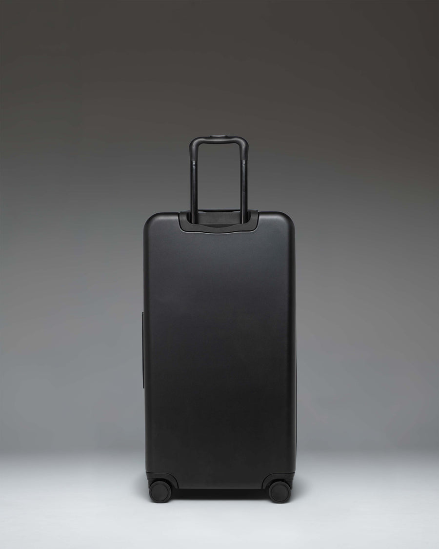 Black Herschel Heritage Hardshell Large Luggage suitcase.