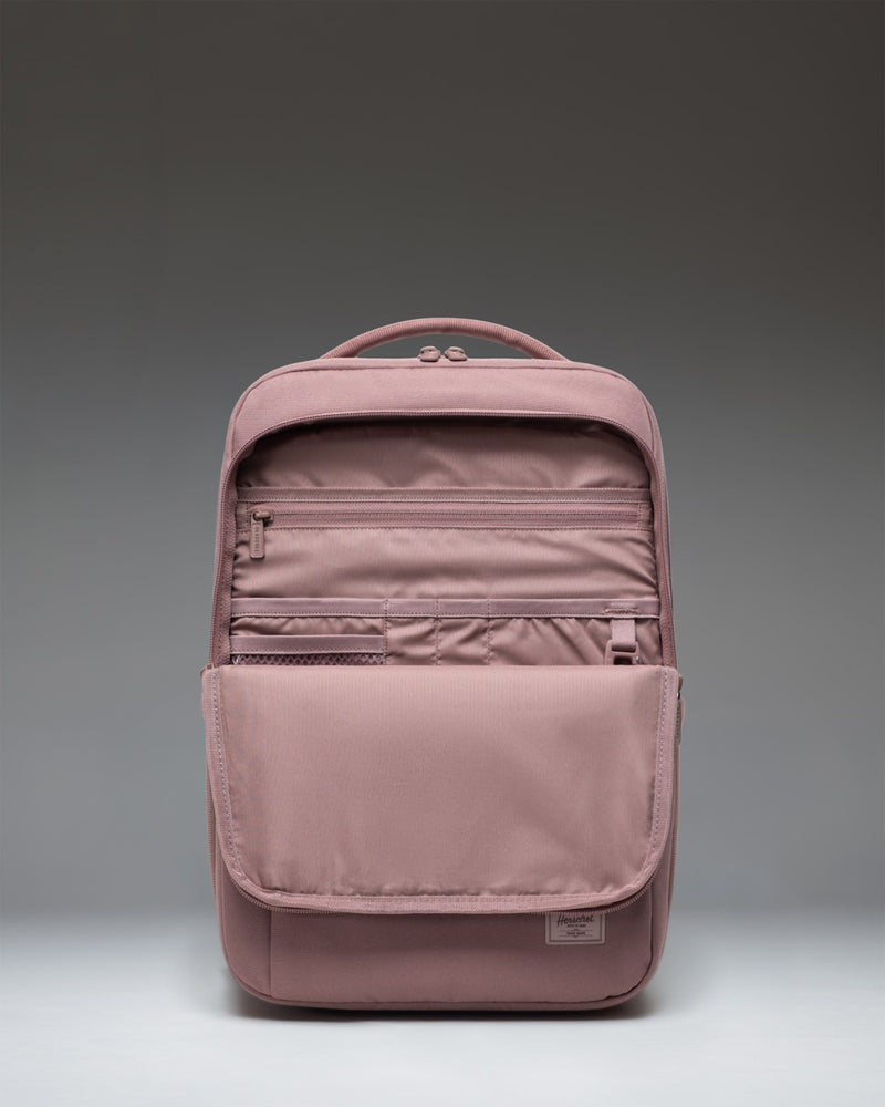 Herschel Supply Co. Kaslo Daypack Tech in Ash Rose Tonal shown from the side to highlight its slim profile and external pocket storage.