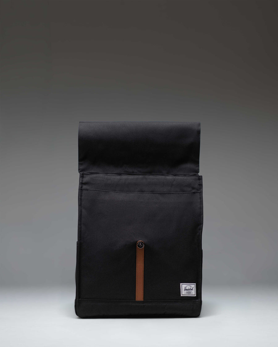 Herschel Supply Co. City Backpack in black, featuring a minimalist design with a single strap magnetic closure and front storage sleeve.