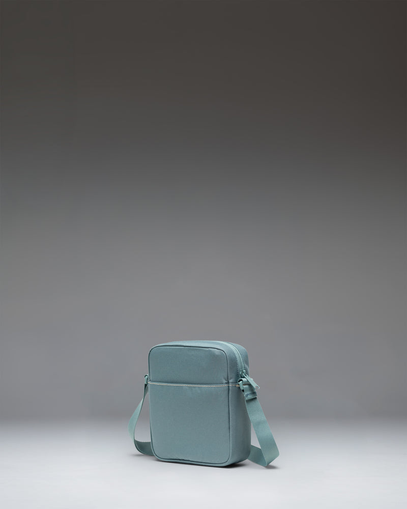 Herschel Heritage Crossbody bag in grey, showing a rectangular polyester design with an adjustable webbing strap and signature diamond detail.
