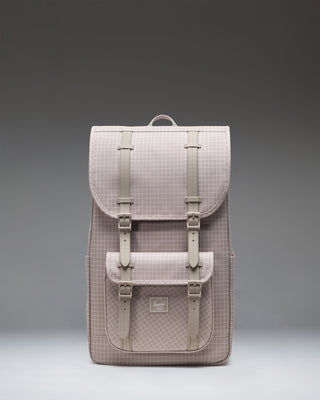 Herschel Little America Backpack in Grid - London Fog grey, featuring a modern grid pattern and brown rubber strap closures.