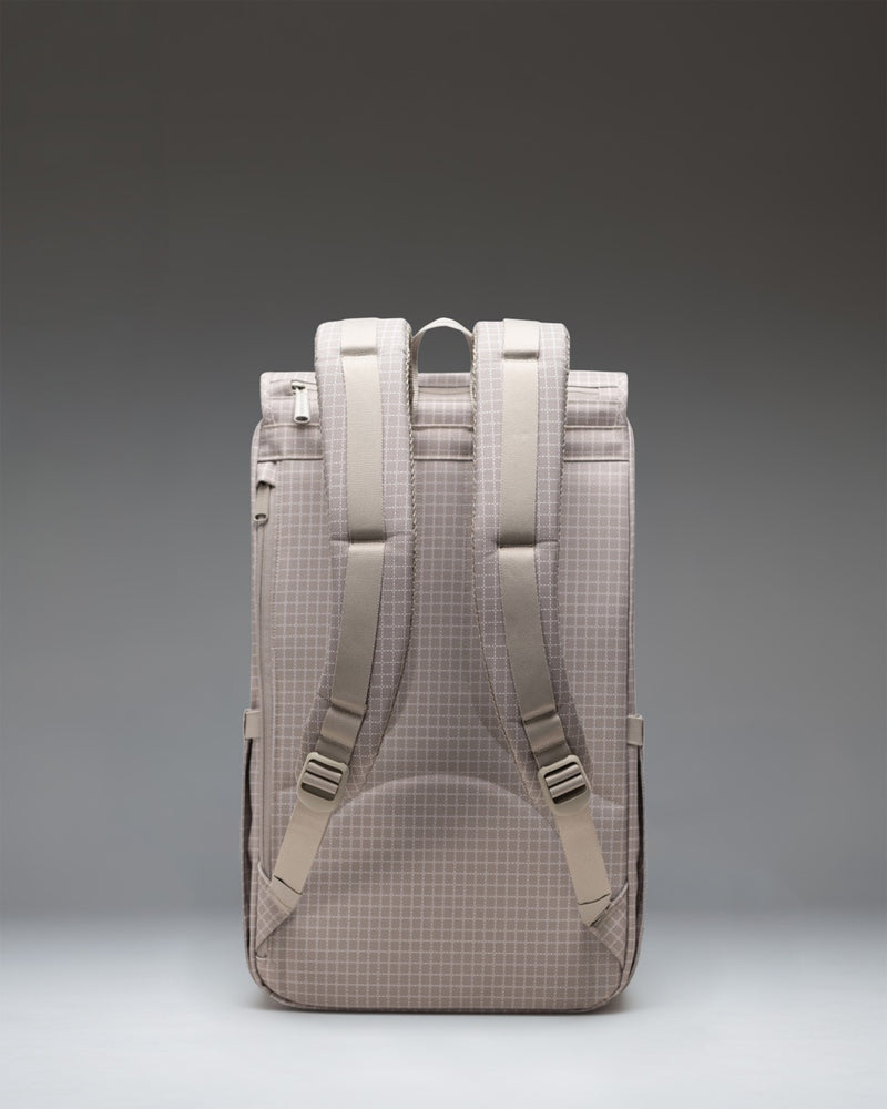 Herschel Little America Backpack in Grid London Fog, featuring a distinct grid pattern with dual rubber straps and a front storage pocket.