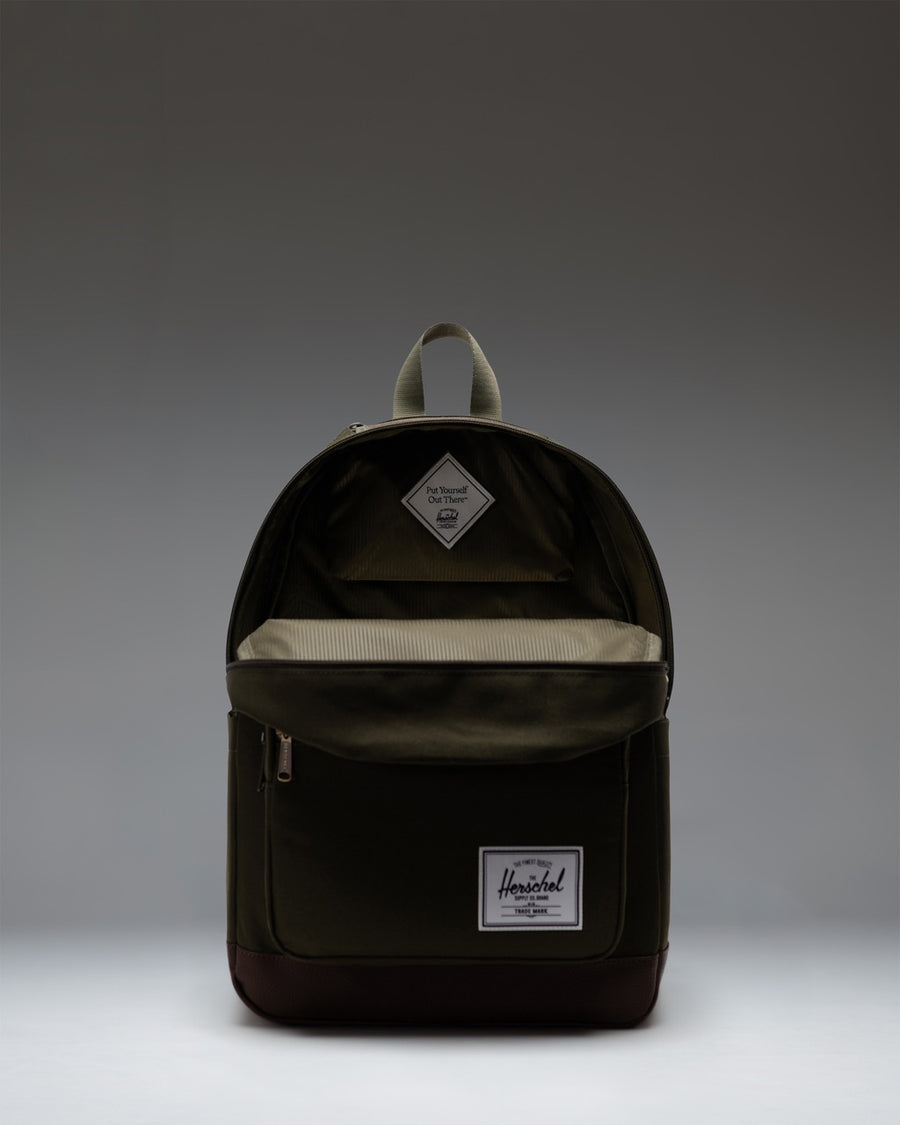Herschel Supply Co. Pop Quiz Backpack in Ivy Green and Chicory Coffee showing a detailed view of the front zipper pocket and fabric texture.