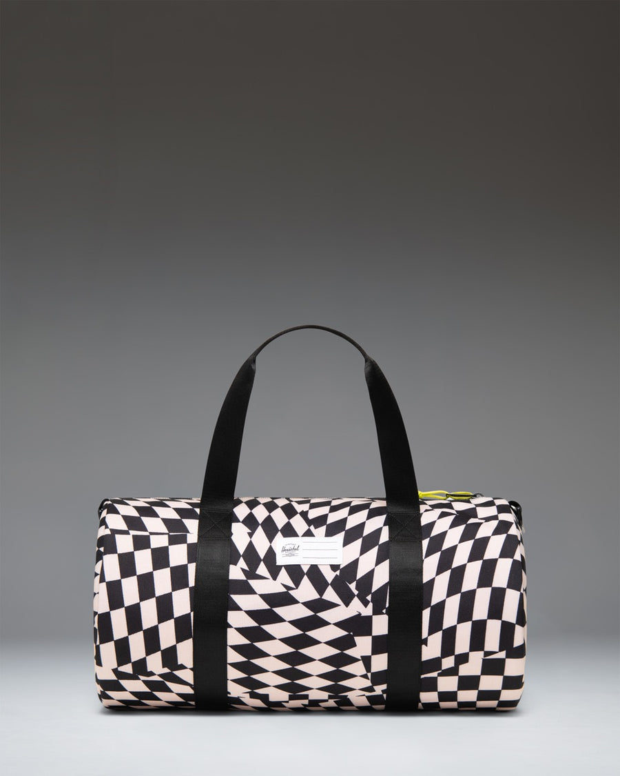 Herschel Classic Duffle Little Herschel bag in Warp Check pattern, featuring a black and white distorted checkerboard design.
