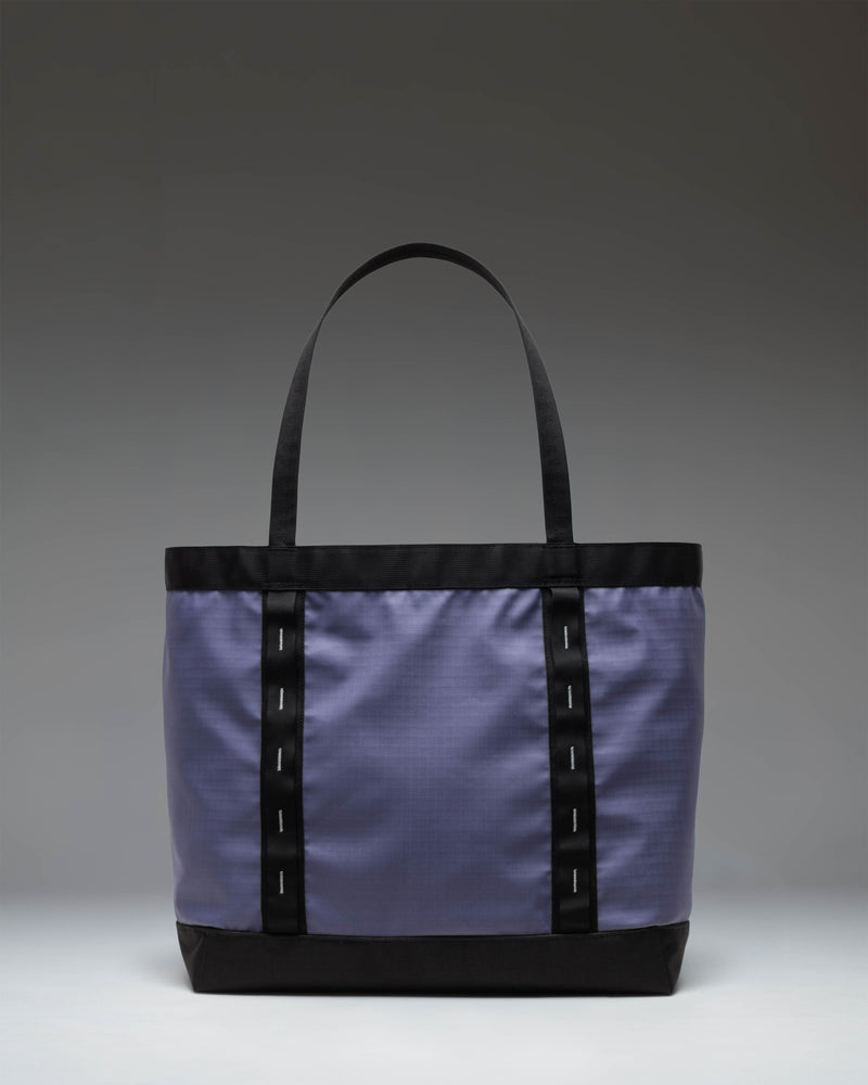 Herschel Supply Co. All Season Gear Tote 33 L in Heron/Black shown from the side highlighting the dual-toned design and durable carrying straps.
