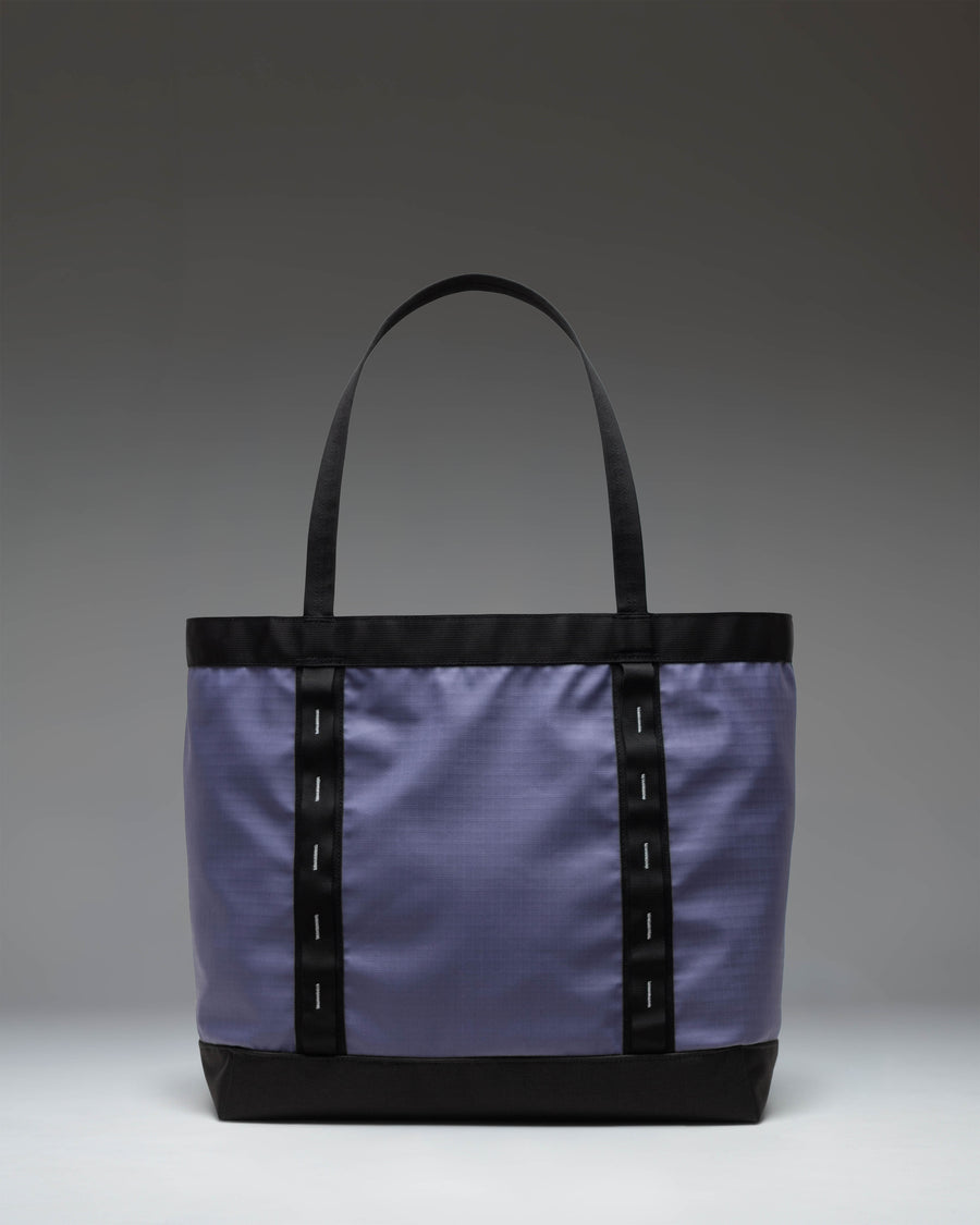 Herschel Supply Co. All Season Gear Tote 33 L in Heron/Black shown from the side highlighting the dual-toned design and durable carrying straps.