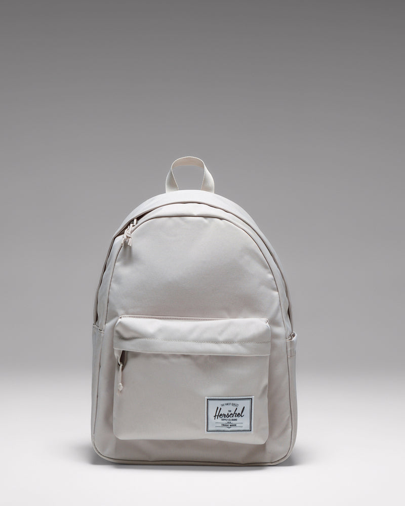 Herschel Classic Backpack in Moonbeam, a light beige everyday backpack shown from the front.