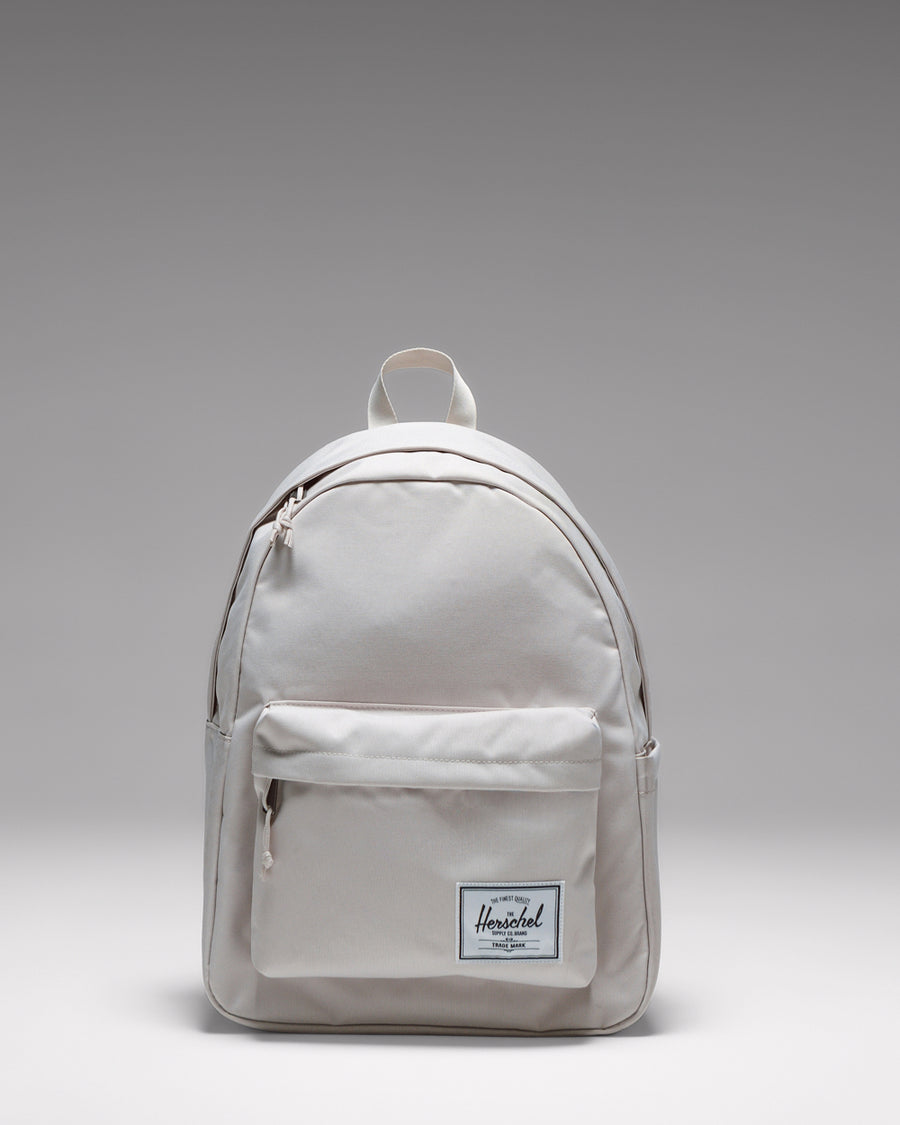 Herschel Classic Backpack in Moonbeam, a light beige everyday backpack shown from the front.