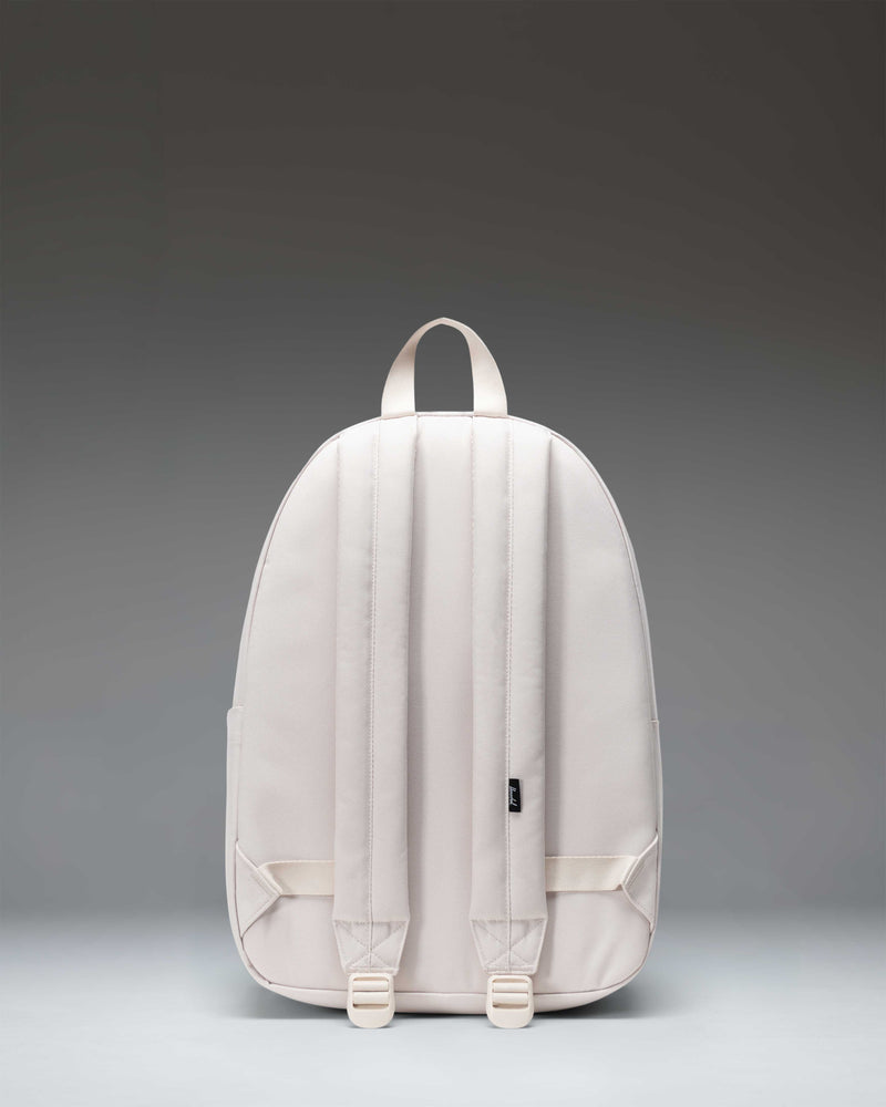 Herschel Classic Backpack in Moonbeam color shown from a three-quarter back angle to display the shoulder straps and clean design.