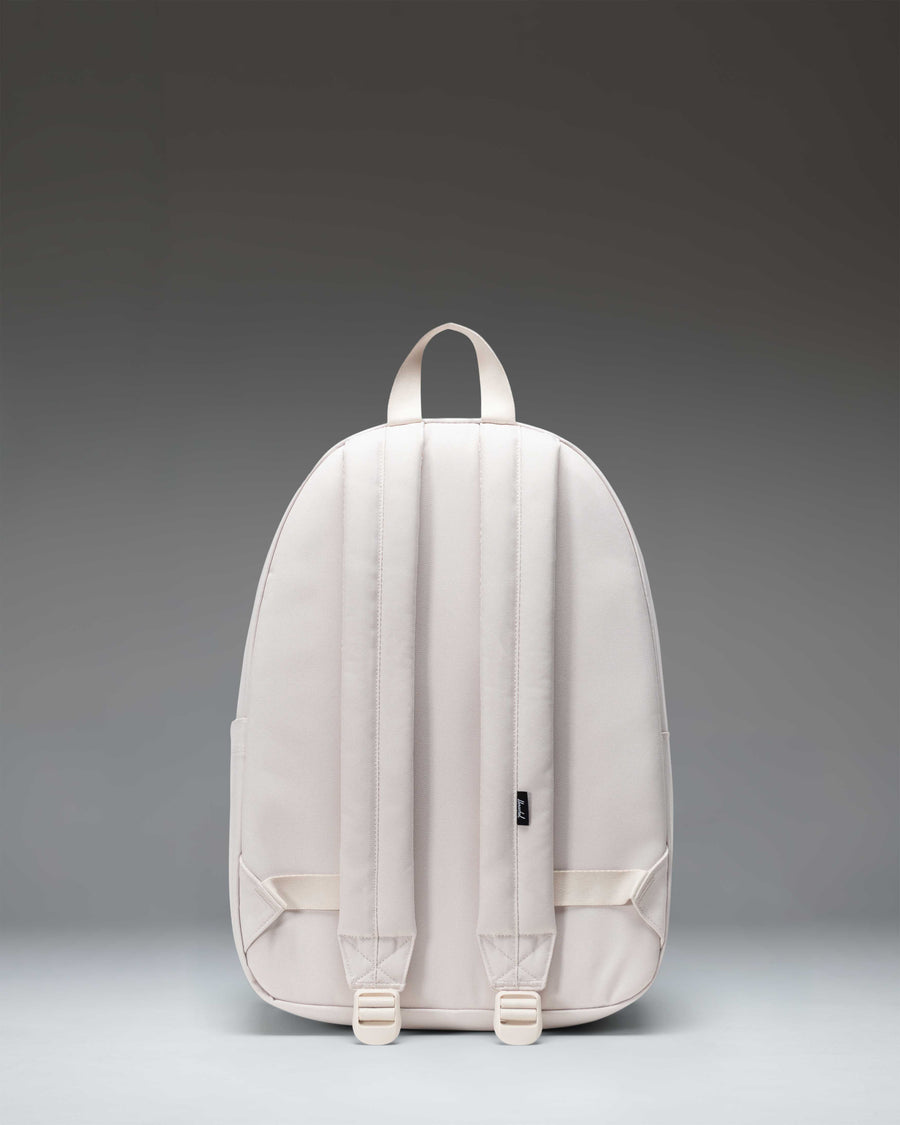 Herschel Classic Backpack in Moonbeam color shown from a three-quarter back angle to display the shoulder straps and clean design.