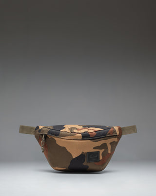 Herschel Classic Hip Pack in Woodland Camo with a black label, shown from the front against a white background.