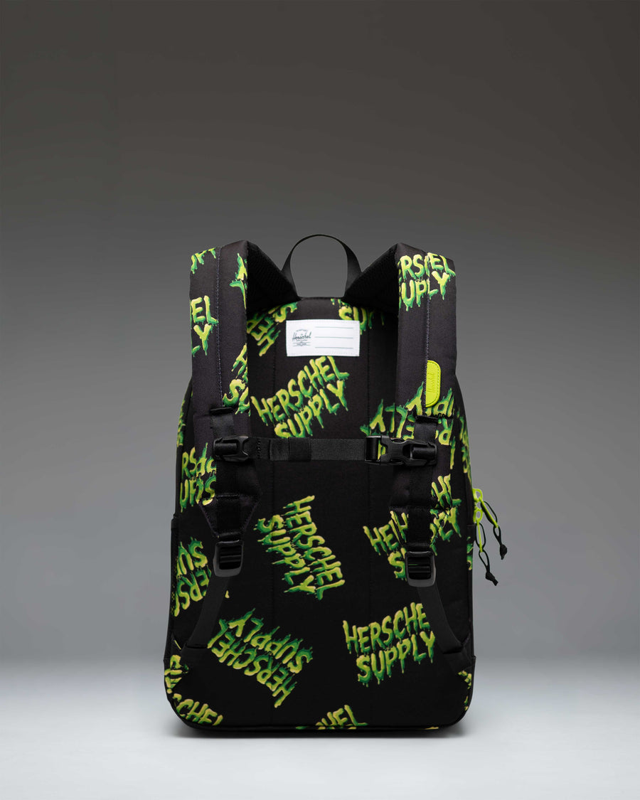 Herschel Heritage Youth Backpack in HSC Slime green, showcasing its classic design, front pocket, and durable straps.
