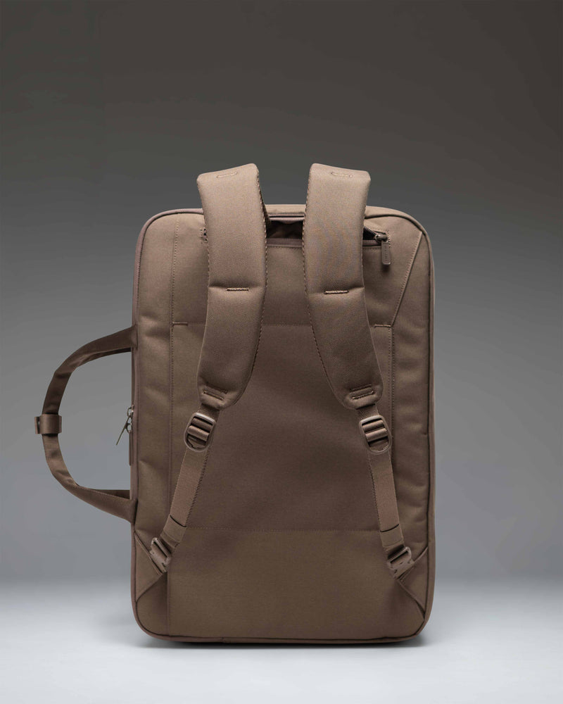 Herschel Supply Co. Bowen Convertible Travel Duffle Tech bag in light brown, featuring top carry handles and a clean, modern design.