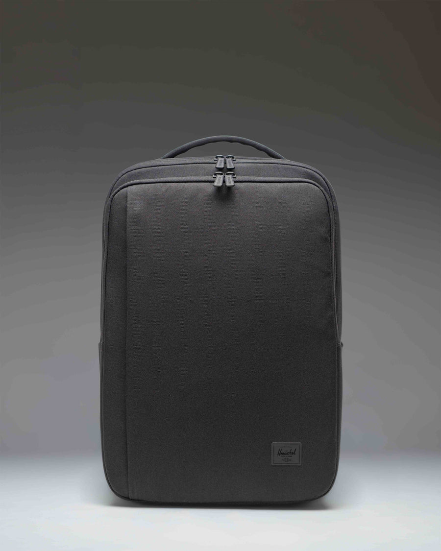 Herschel Supply Co. Kaslo Travel Backpack Tech in black. Clean front view showcasing the durable material and zippered compartments.