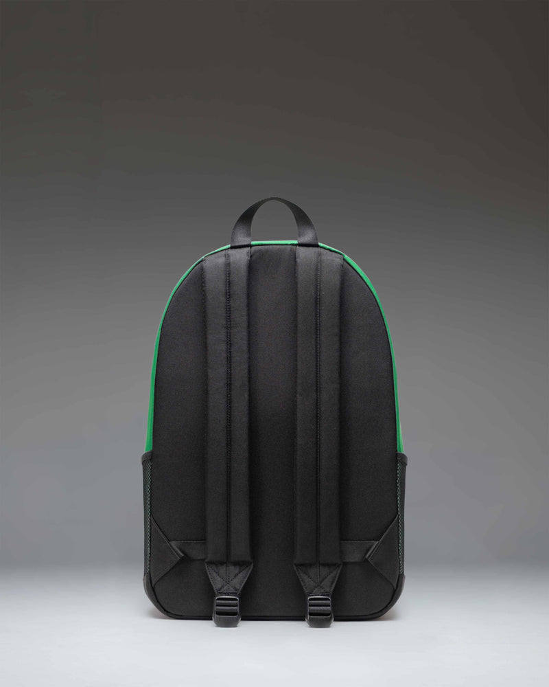 Herschel Supply Co. Kaine Backpack in Varsity Pine green, showing a detailed view of the front zippered pockets, key clip, and durable construction.