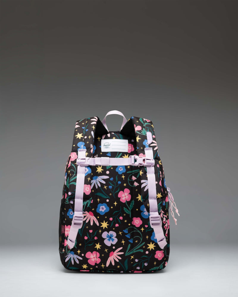 A Herschel Heritage Kids Backpack size guide chart showing dimensions for Kids (15L, 14"x10.5"x5") and Youth (26L, 17"x12"x6").