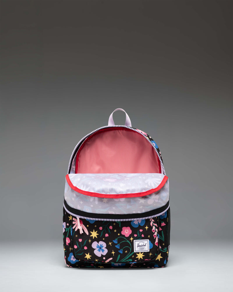 Herschel Heritage Kids Backpack in Enchanted Garden, a dark backpack featuring a colorful floral pattern with pink, white, and blue flowers.