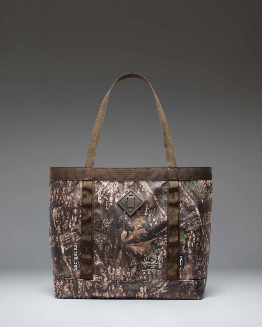 Herschel Supply Co. Realtree All Season Gear Tote 33L featuring the Realtree APX camouflage pattern.