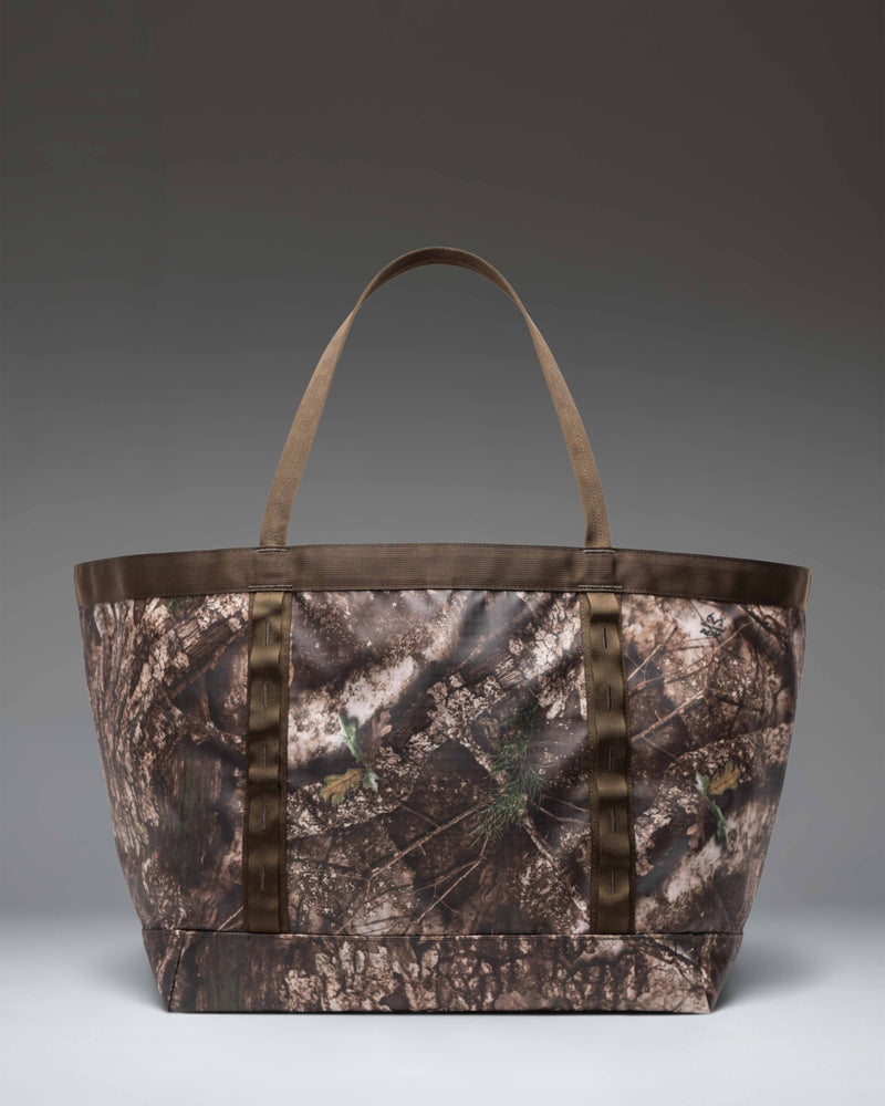 Herschel Supply Co. Realtree All Season Gear Tote 63 L in Realtree APX Camo, showing a detailed view of the large camouflage utility tote bag.