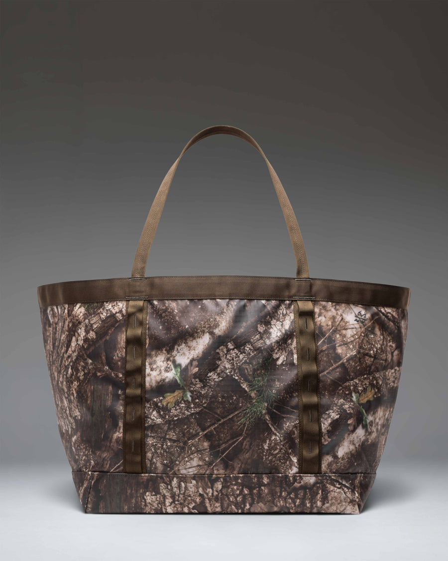 Herschel Supply Co. Realtree All Season Gear Tote 63 L in Realtree APX Camo, showing a detailed view of the large camouflage utility tote bag.