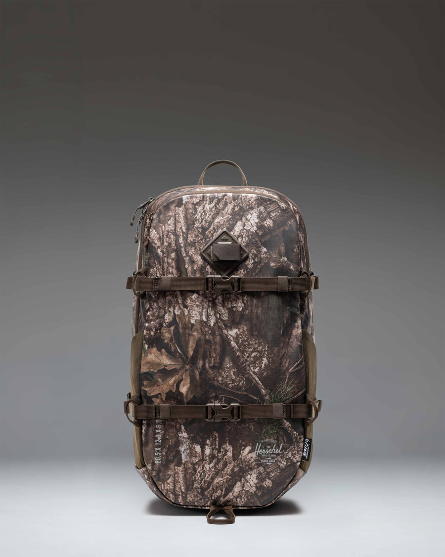 Herschel Supply Co. Realtree All Season Backpack 29 L in Realtree APX Camo pattern, showing the front view with straps and pockets.