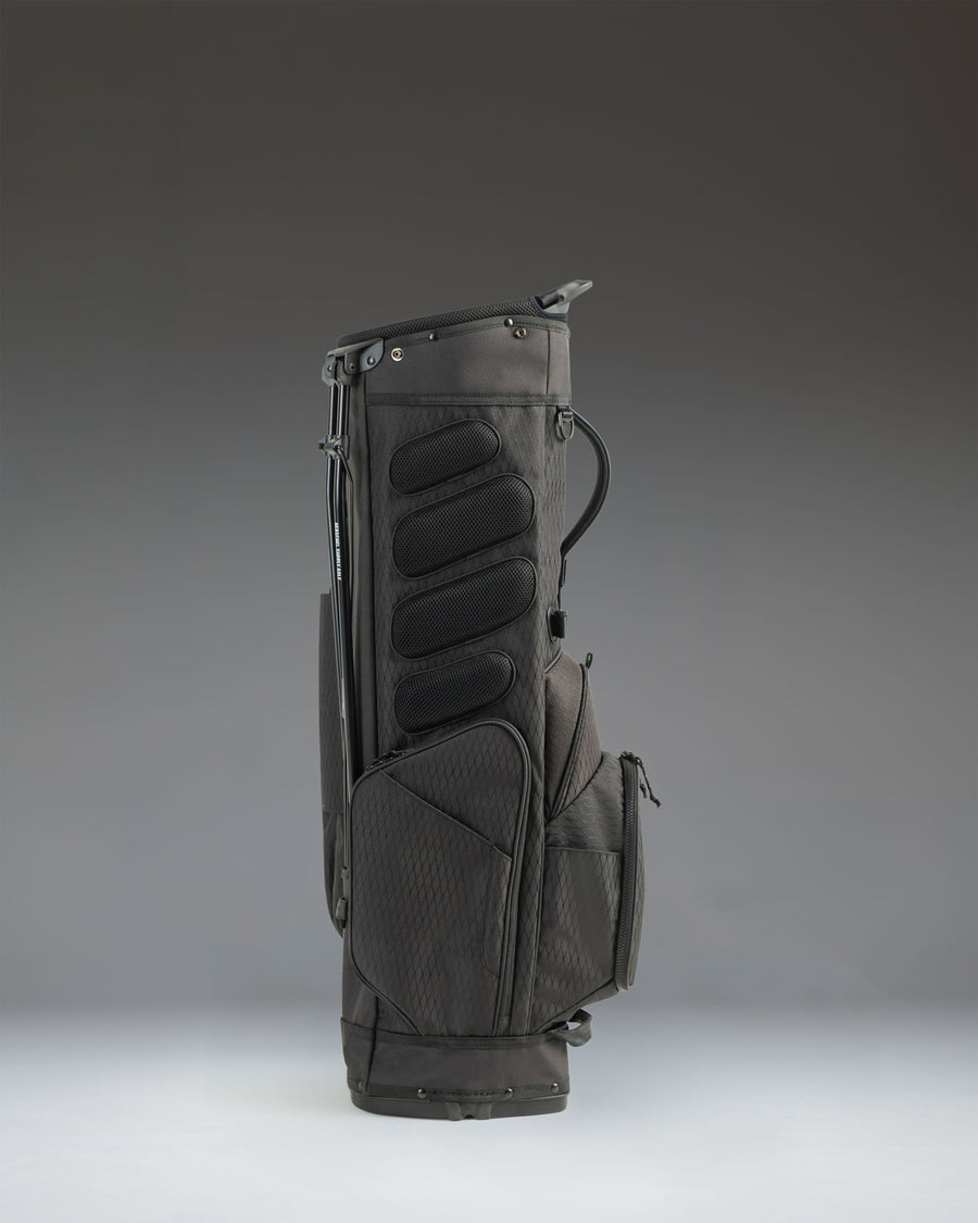 Black Herschel Watt Stand Bag golf bag featuring durable stand legs and comfortable carrying straps.