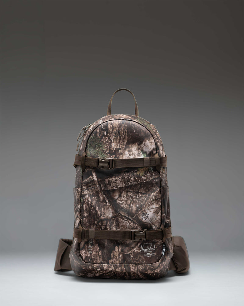 Herschel Supply Co. Realtree All Season Resort Backpack 14L in Realtree APX Camo pattern, showing a front view.
