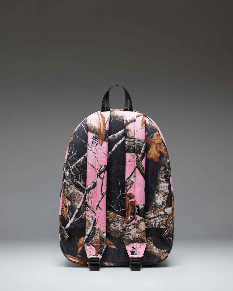 Herschel Classic Backpack in Realtree Edge Camo Pink/Black, featuring a pink and black camouflage pattern with front pocket and shoulder straps.