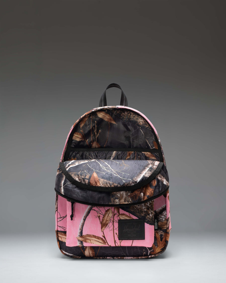 Herschel Supply Co. Classic Backpack in Realtree Edge Camo Pink/Black featuring a vibrant pink and black camouflage pattern.