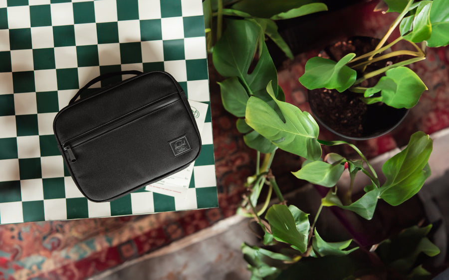 Herschel Supply Co. Pop Quiz Lunch Box in Black Tonal, a durable insulated lunch bag with a convenient front zippered pocket.