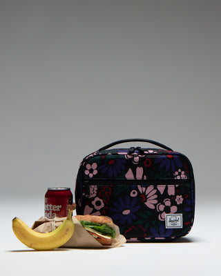 Herschel Supply Co. Pop Quiz Lunch Box in Moody Bloom, featuring a dark blue fabric with a vibrant pink and purple floral pattern.