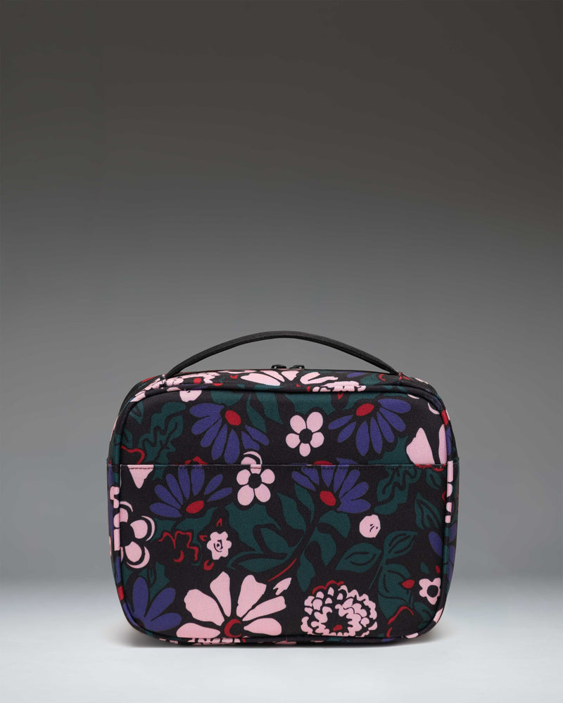 Herschel Supply Co. Pop Quiz Lunch Box in Moody Bloom floral print, showing the insulated main compartment and front pocket.