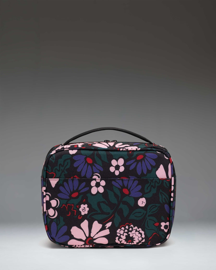Herschel Supply Co. Pop Quiz Lunch Box in Moody Bloom floral print, showing the insulated main compartment and front pocket.