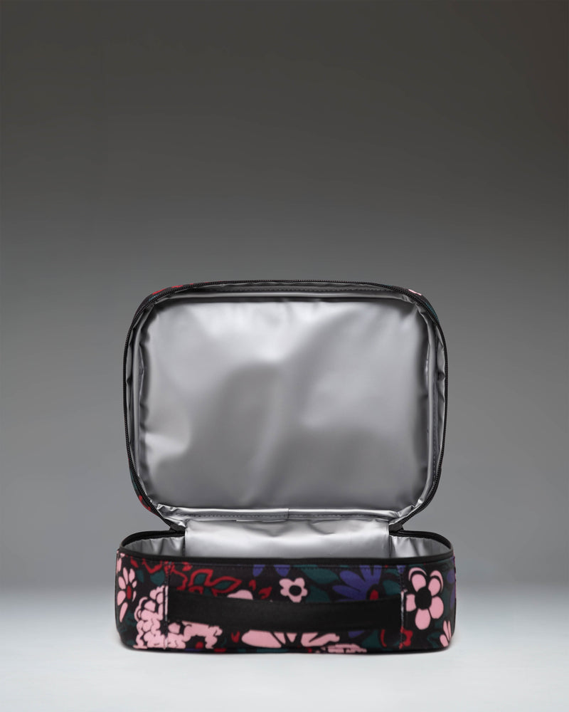 Herschel Supply Co. Pop Quiz Lunch Box in Moody Bloom, featuring a dark floral pattern.