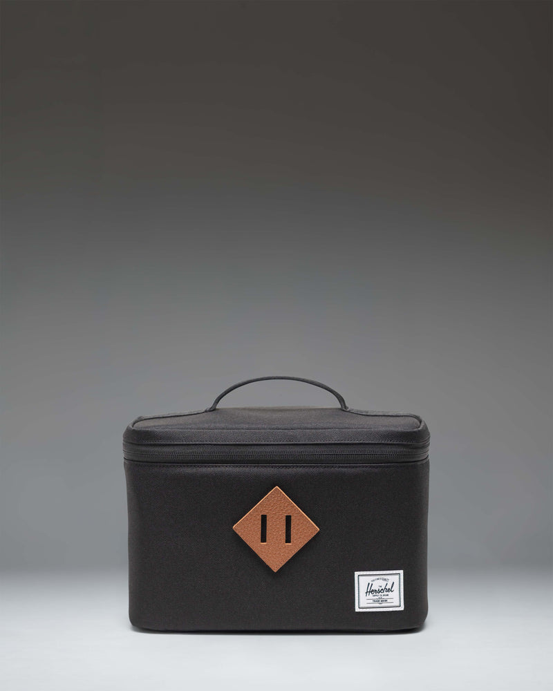 Herschel Heritage Lunch Box in black, showing the front view with the signature diamond accent and woven label.