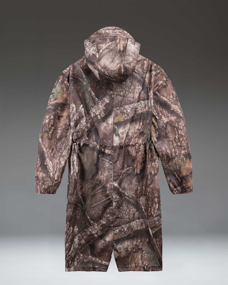Herschel Supply Co. Realtree Skeena raincoat for women in a brown and green leafy APX camouflage pattern.