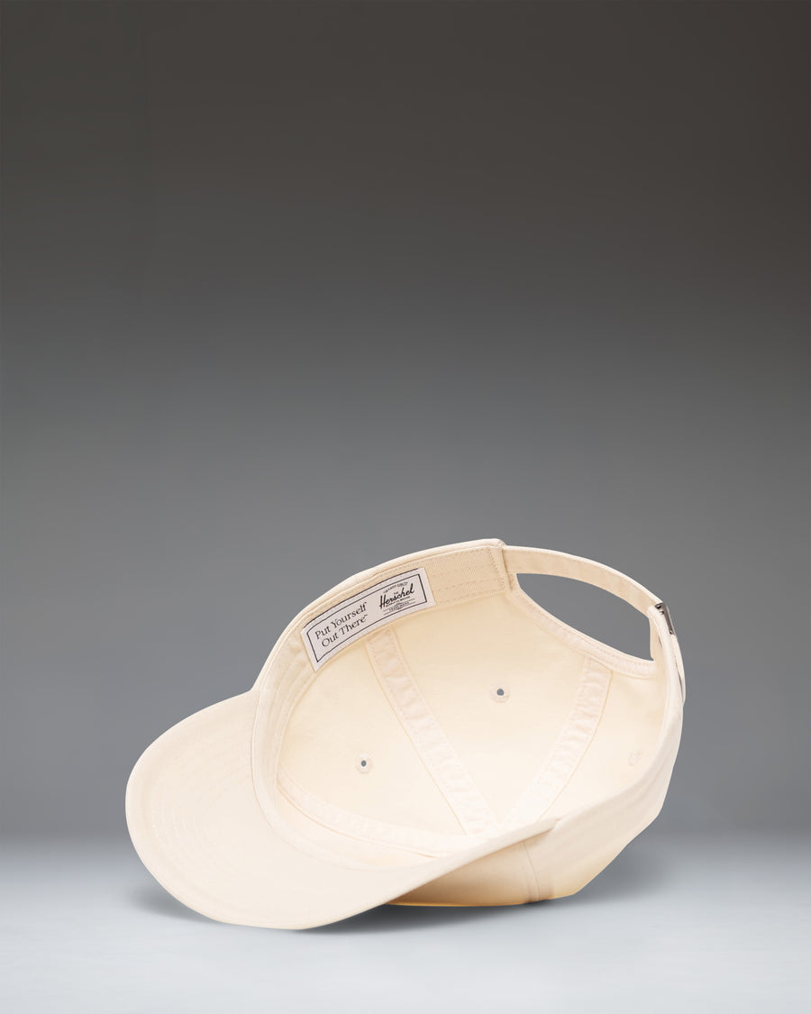 Herschel Supply Co Sylas Vintage Cotton Cap in Vintage White, shown from the side.