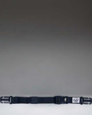 Herschel Supply Co. Sternum Strap in navy blue, designed to attach to backpack shoulder straps for added support and comfort.
