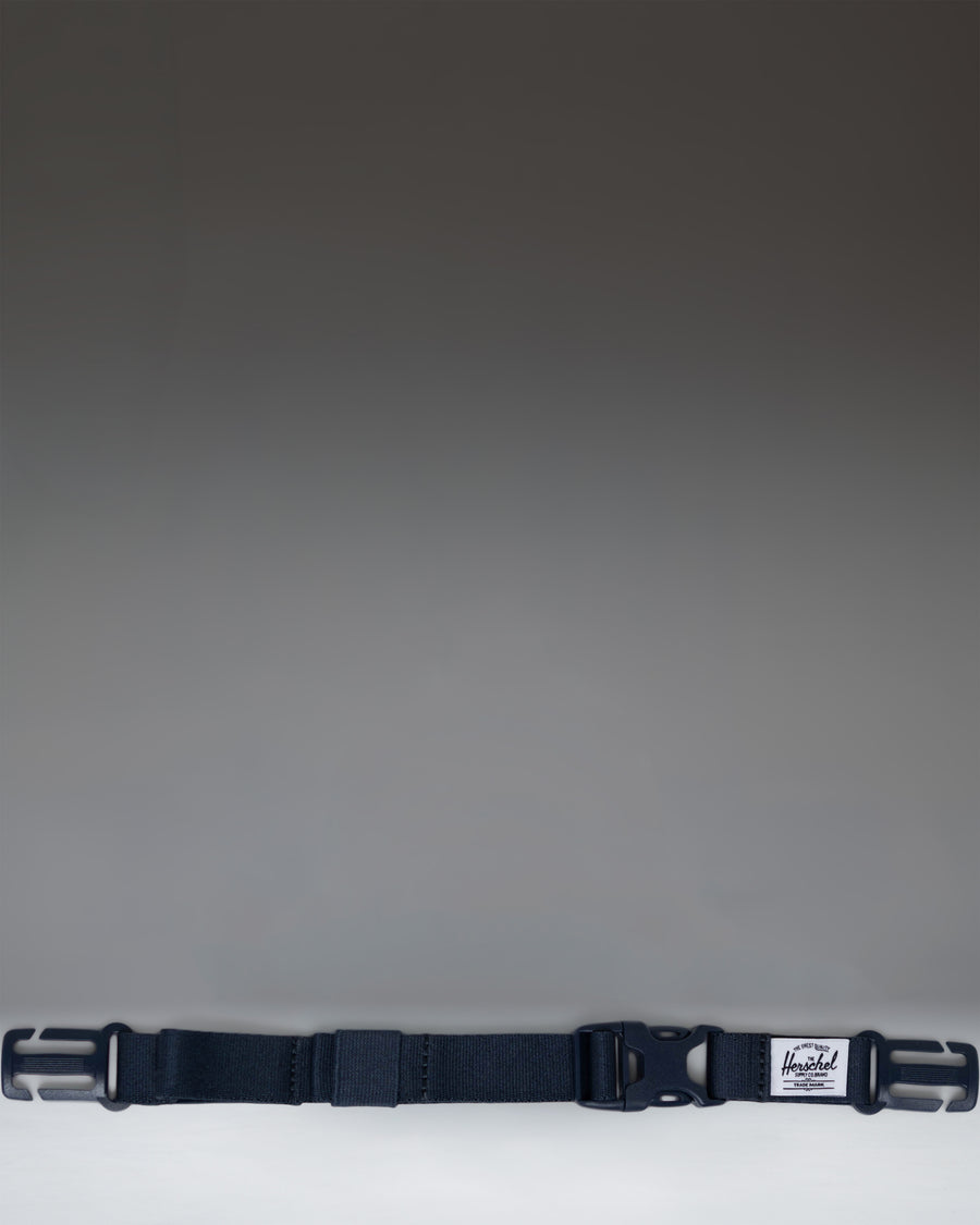 Herschel Supply Co. Sternum Strap in navy blue, designed to attach to backpack shoulder straps for added support and comfort.