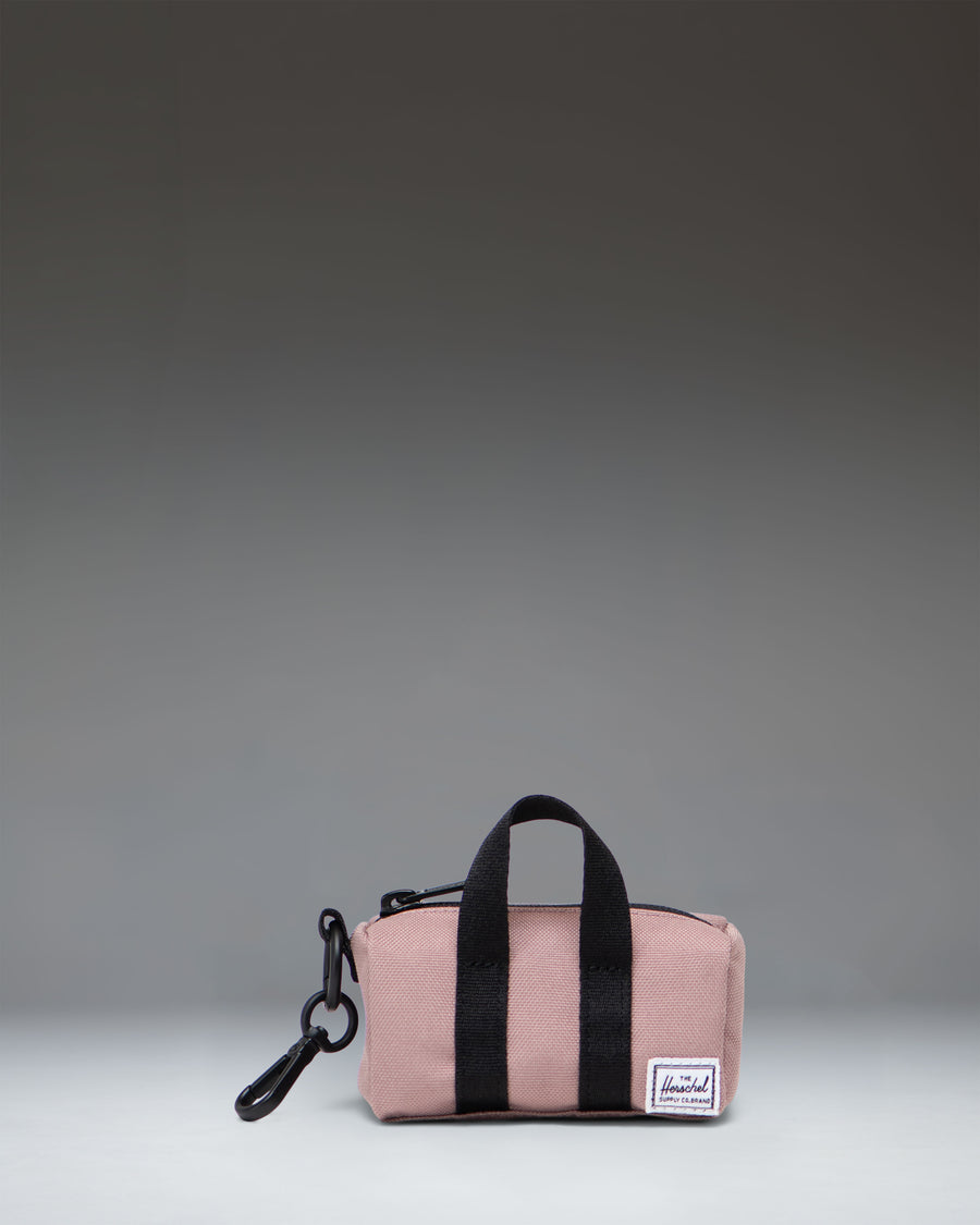 Herschel Novel Duffle Bag Charm in Ash Rose, a miniature pink duffle bag accessory with a metal keyring clip.