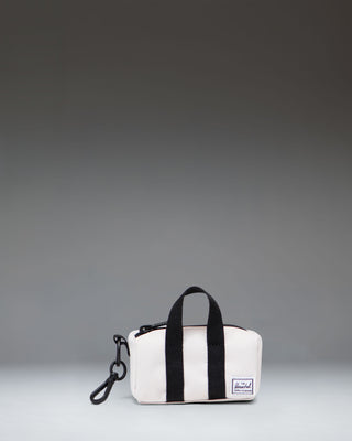 Herschel Novel Duffle Bag Charm in the light beige Moonbeam color, showing a miniature version of the classic duffle bag.