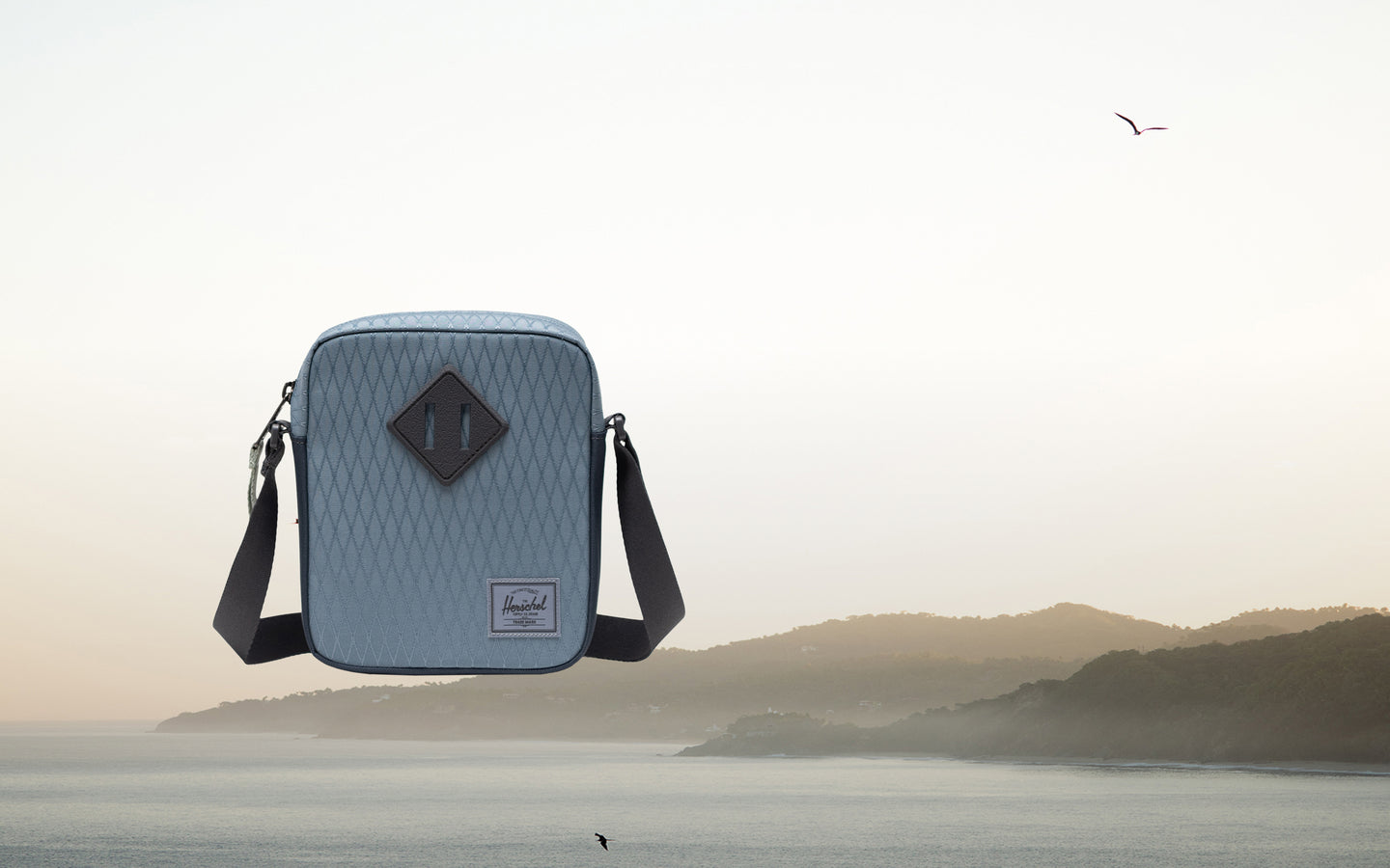 Herschel Heritage Crossbody bag in Blue Mirage Diamond and Sea Storm blue.