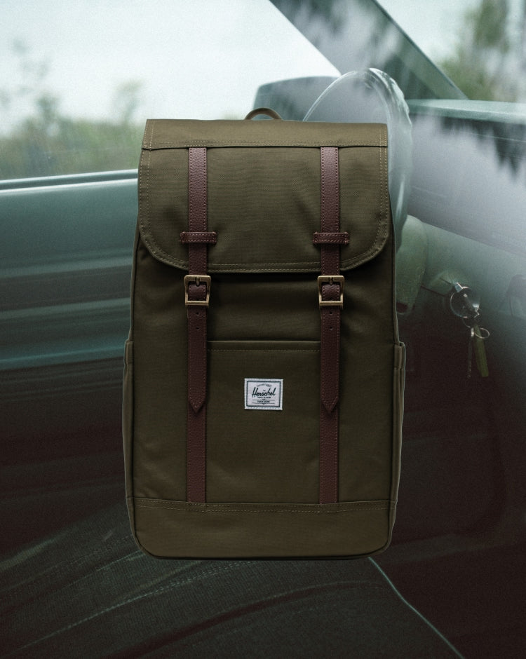 Herschel Retreat Backpack in Ivy Green shown on a mobile screen lifestyle view.