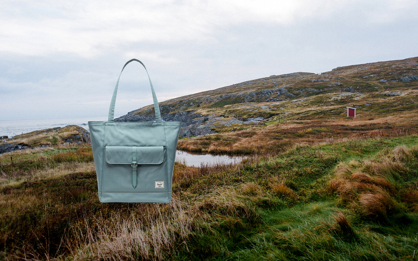 Herschel Supply Co. Retreat Tote bag being worn by a person on a beach setting.