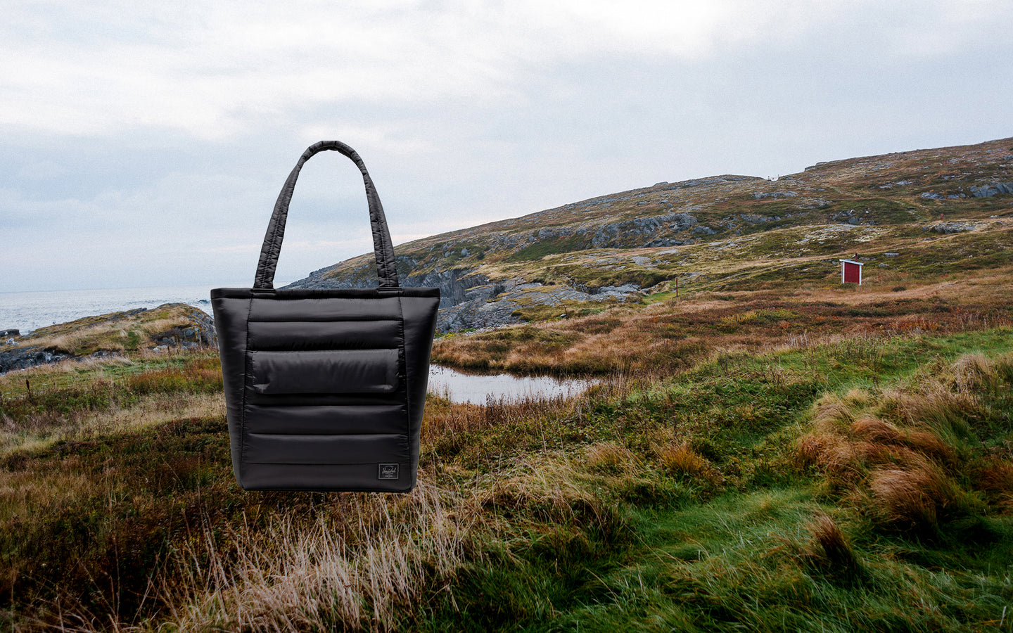 Herschel Retreat Tote in black, showcasing a clean, classic design ideal for daily use or travel.