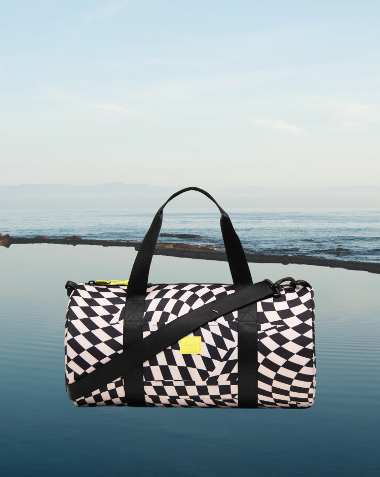 Herschel Classic Duffle Little Herschel in Warp Check patterned print.