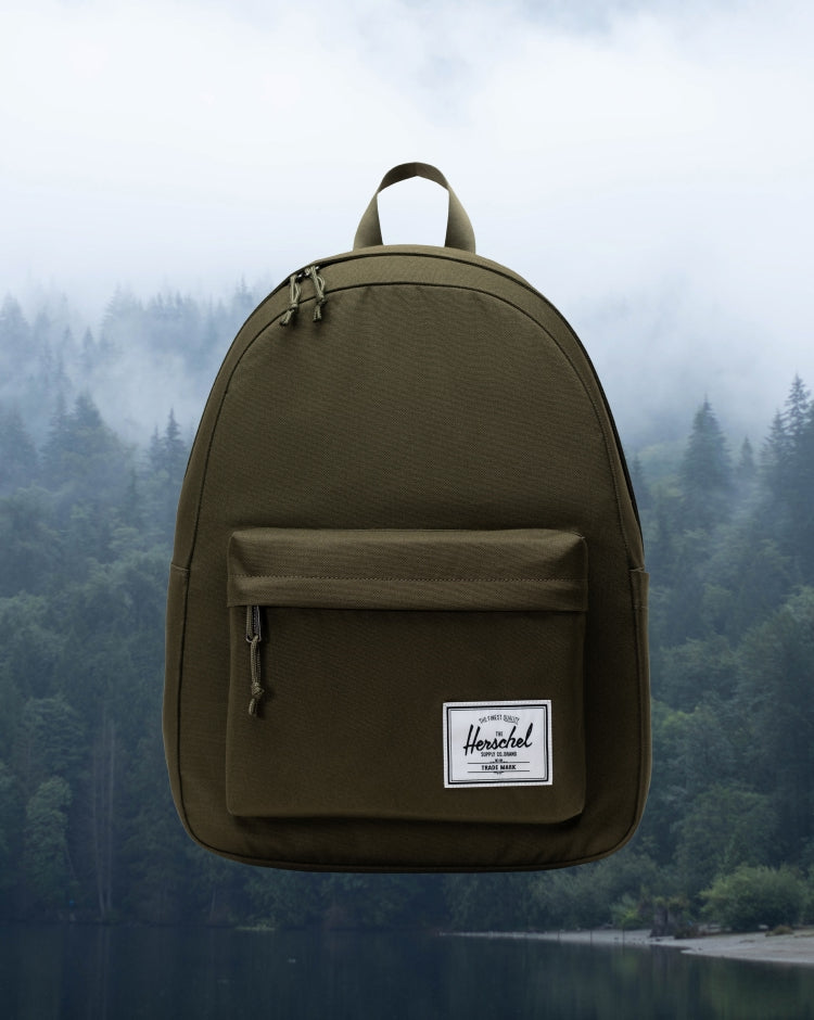 Herschel Supply Co. Classic Backpack in Ivy Green, showcasing its clean design and front storage pocket.