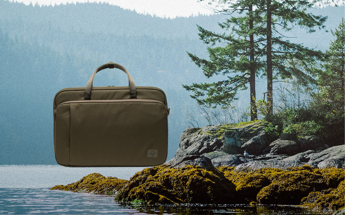 Herschel Supply Co. Bowen Convertible Travel Duffle Tech in Ivy Green Tonal, shown from the front on a desktop background.
