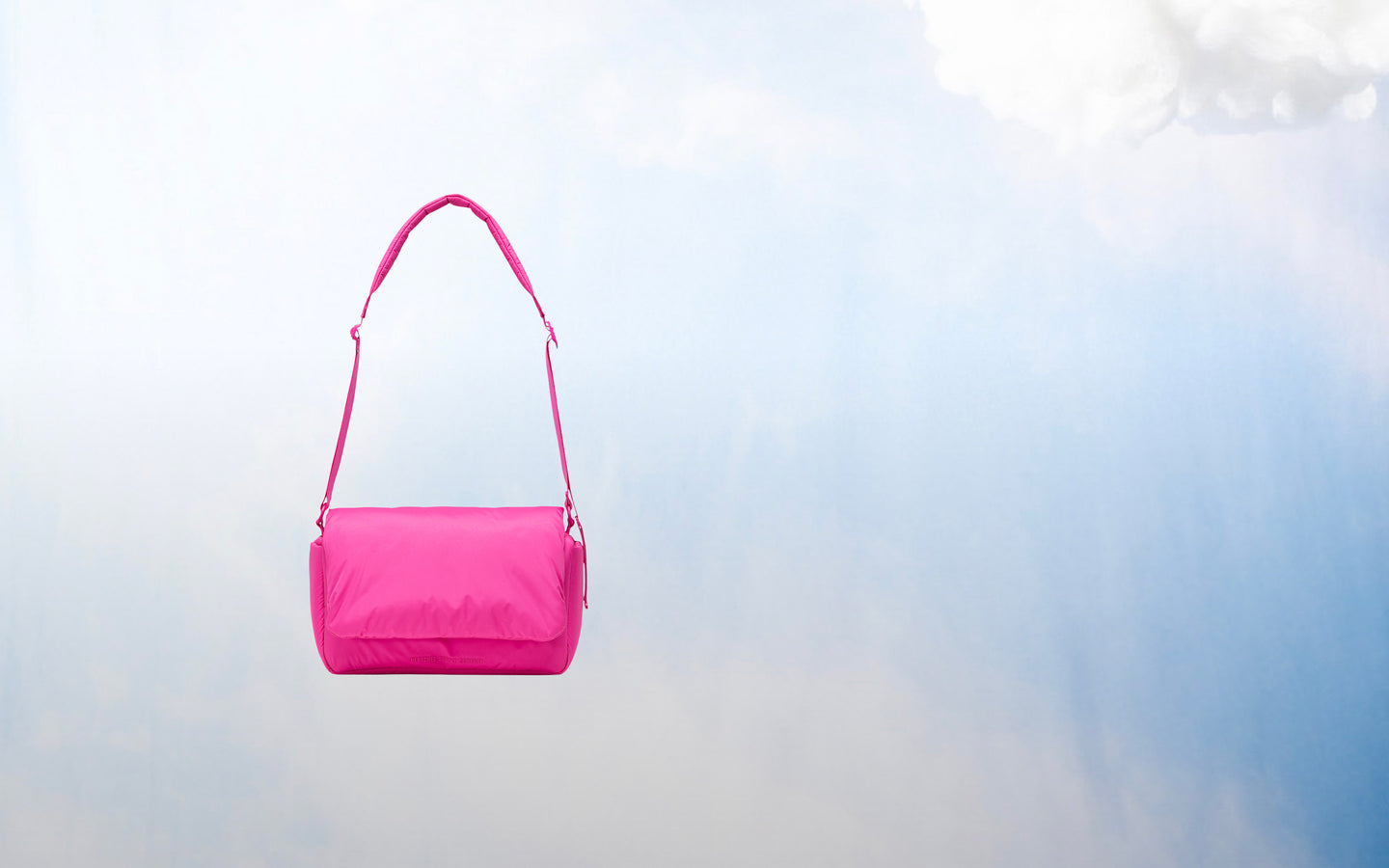 Herschel Supply Co. Cloudform Crossbody bag in Rose Violet shown from a front lifestyle view on a desktop background.